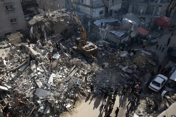 Members of the Palestinian Civil Defense remove the rubble of a destroyed home as they search for the bodies of Palestinians killed during the conflict in Khan Younis, southern Gaza Strip, 20 December 2025. (EPA)