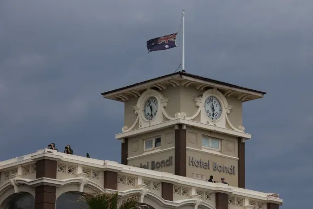 Security watch over the "Light Over Darkness" vigil from the roof of the Bondi Hotel commemorating victims and survivors of a deadly mass shooting during a Jewish Hanukkah celebration at Bondi Beach on December 14, in Sydney, Australia, December 21, 2025. (Reuters)