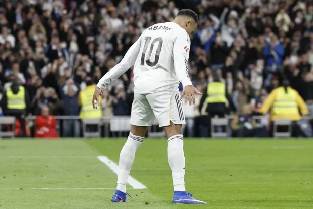 Real Madrid's French forward #10 Kylian Mbappe celebrates scoring his team's second goal during the Spanish league football match between Real Madrid CF and Sevilla FC at Santiago Bernabeu Stadium in Madrid on December 20, 2025. (AFP)