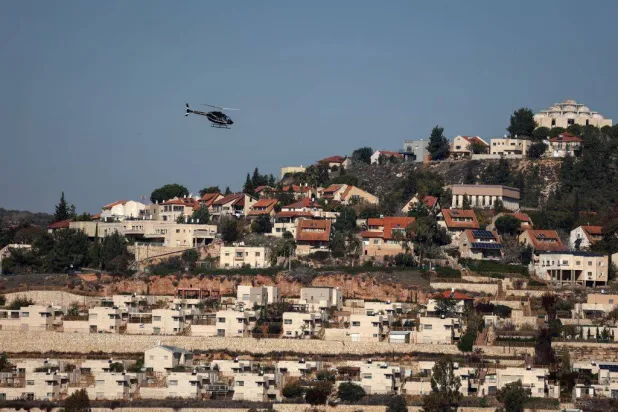  A helicopter flies over the Israeli settlement of Shilo in the occupied West Bank on December 14, 2025. (AFP) 