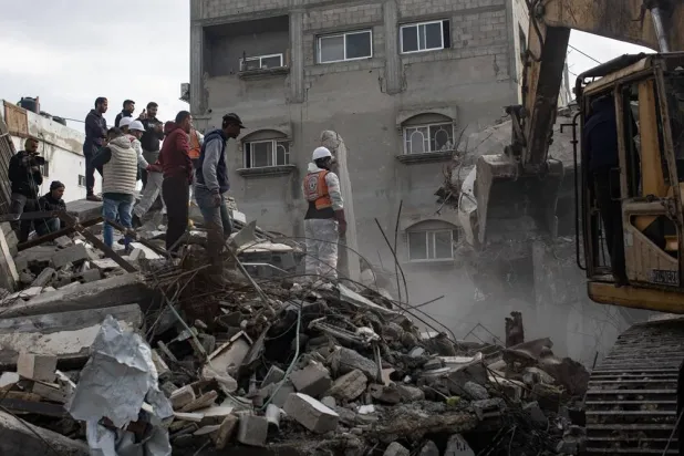 Members of the Palestinian Civil Defense remove the rubble of a destroyed home as they search for the bodies of Palestinians killed during the conflict in Khan Younis, southern Gaza Strip, 20 December 2025. (EPA)