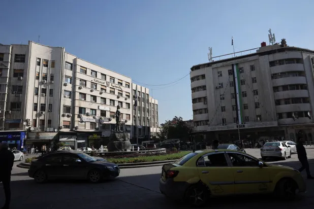 People walk along a street in Damascus, Syria, December 18, 2025. REUTERS/Khalil Ashawi 
