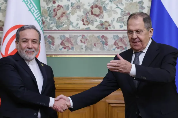 Russian Foreign Minister Sergei Lavrov, right, and Iranian Foreign Minister Abbas Araghchi shake hands after a joint news conference at Zinaida Morozova's Mansion in Moscow, Wednesday, Dec. 17, 2025. (Ramil Sitdikov/Pool Photo via AP) 