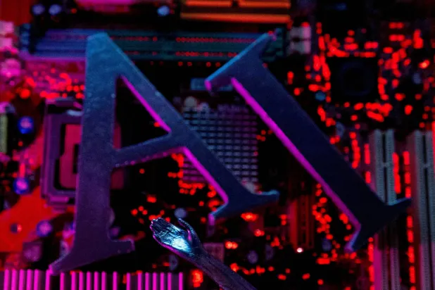 FILE PHOTO: AI (Artificial Intelligence) letters and robot hand are placed on computer motherboard in this illustration created on June 23, 2023. REUTERS/Dado Ruvic/Illustration/File Photo