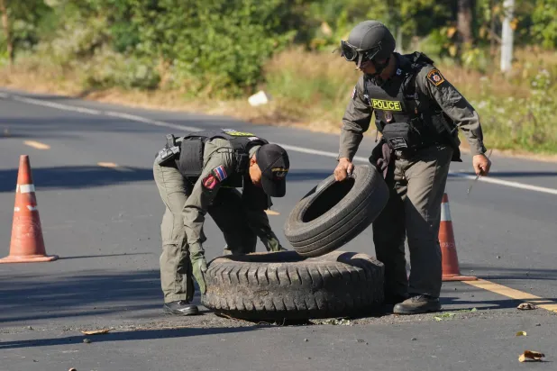 Members of a Thai Explosive Ordnance Disposal team inspect the site of a rocket attack during clashes between Thai and Cambodian soldiers in Kantharalak district of Sisaket province, Thailand, Monday, Dec. 15, 2025. (AP Photo/Sakchai Lalit)