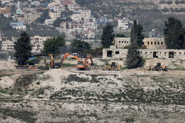 Israeli bulldozers level land at the evacuated Israeli settlement of Sanur, near the West Bank city of Jenin, 23 December 2025. (EPA) 