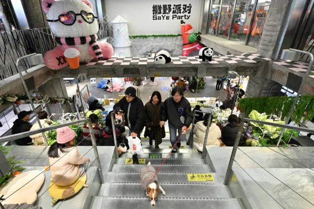 People visit a shopping center in Beijing on December 20, 2025. (AFP)