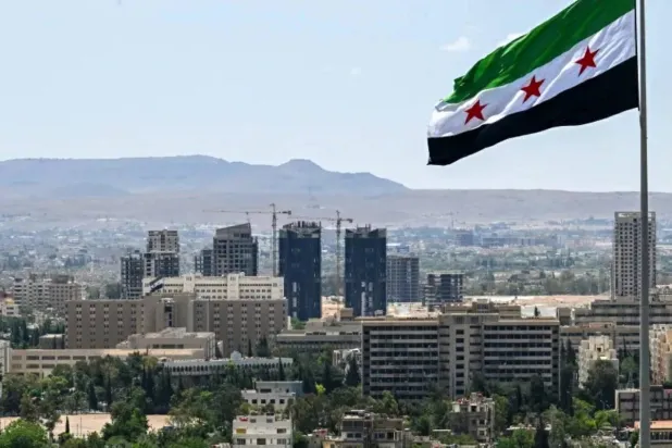 A large Syrian flag flutters above Tishreen Park in Damascus, June 4, 2025. (AFP)