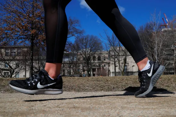 A jogger wearing Nike shoes runs along the Charles River in Cambridge, Massachusetts, US, March 18, 2019. (Reuters)