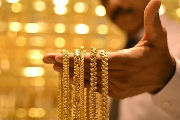 A salesman displays gold chains at an Indian jewelry store in September. Idrees MOHAMMED / AFP
