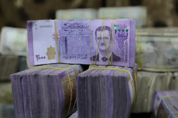 Syrian pounds are pictured inside an exchange currency shop in Azaz, Syria February 3, 2020. Picture taken February 3, 2020. REUTERS/Khalil Ashawi/File Photo 