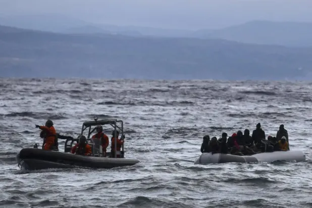 A dinghy transporting dozens of refugees and migrants is pulled towards Greece's Lesbos island after being rescued by a war ship during their sea crossing between Türkiye and Greece on February 29, 2020. Aris Messinis, AFP/File picture
