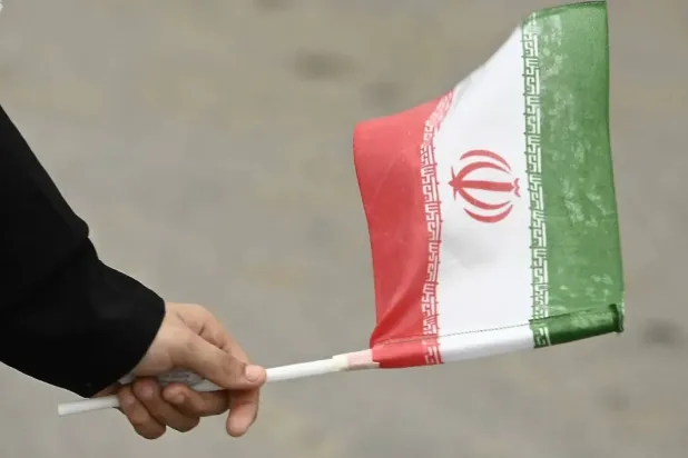 A Pakistani woman holds a national flag of Iran during a rally in solidarity with the Iranian people, in Karachi, Pakistan, 22 June 2025. EPA/SHAHZAIB AKBER
