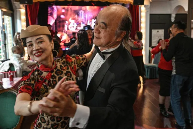 On any given day, multiple venues in Shanghai host hours-long dance sessions, a phenomenon born of the city's deeply of ballroom culture. Hector RETAMAL / AFP
