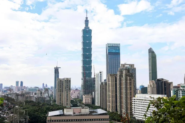 The Taipei 101 building is seen among residential and commercial buildings in Taipei on December 18, 2025. (AFP)