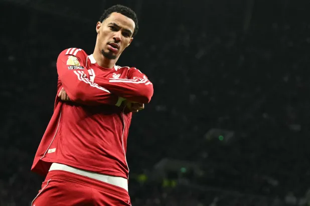 Liverpool's French striker #22 Hugo Ekitike strikes a pose as he celebrates scoring their second goal for 0-2 during the English Premier League football match between Tottenham Hotspur and Liverpool at the Tottenham Hotspur Stadium in London, on December 20, 2025. (Photo by JUSTIN TALLIS / AFP) 