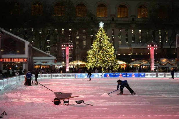  Workers clear snow from the ice rink at Bryant Park during a winter storm in New York City, US, December 26, 2025. (Reuters)