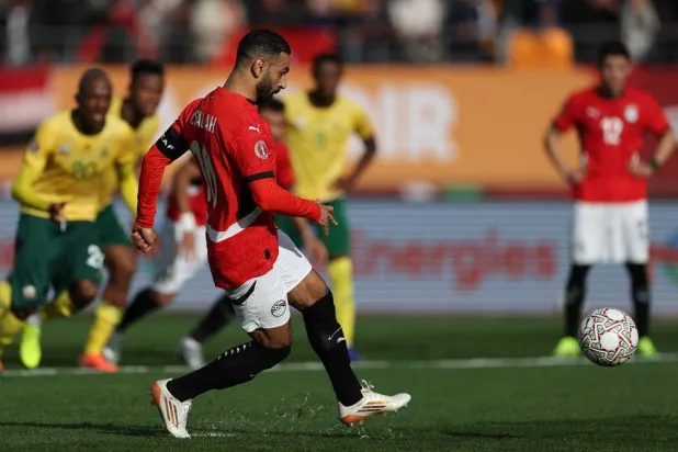  Egypt's forward #10 Mohamed Salah shoots from the penalty spot to score the team's first goal during the Africa Cup of Nations (CAN) Group B football match between Egypt and South Africa at Adrar Stadium in Agadir on December 26, 2025. (AFP) 