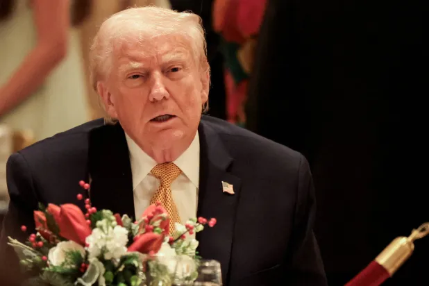 US President Donald Trump takes part in a Christmas Eve dinner in the ballroom of his Mar-a-Lago club in Palm Beach, Florida, US, December 24, 2025. REUTERS/Jessica Koscielniak