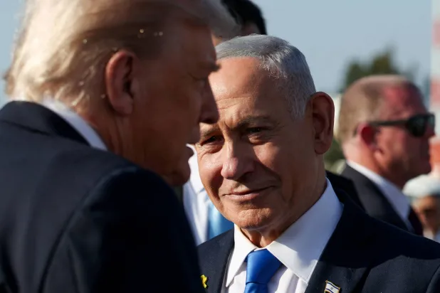 Israeli Prime Minister Benjamin Netanyahu looks on next to US President Donald Trump as Trump leaves Israel en route to Sharm El-Sheikh, Egypt, to attend a world leaders' summit on ending the Gaza war, amid a US-brokered prisoner-hostage swap and ceasefire deal between Israel and Hamas, at Ben Gurion International Airport in Lod, Israel, October 13, 2025. (Reuters)