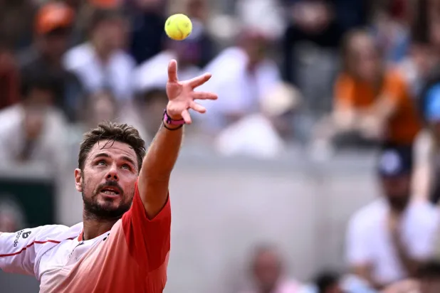 Switzerland's Stan Wawrinka serves to Great Britain's Jacob Fearnley during their men's singles match on day 2 of the French Open tennis tournament at the Roland-Garros Complex in Paris on May 26, 2025. (AFP)