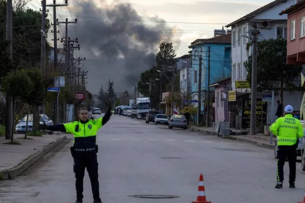 Smoke rises in the background as police block a road leading to a site where Turkish police launched an operation on a house believed to contain suspected ISIS militants, and where, according to state media, seven officers were wounded in a clash, in Yalova province, Türkiye, December 29, 2025. (Reuters)