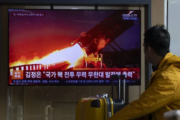 A person watches a TV news report at Seoul Station in Seoul, South Korea, 29 December 2025. According to South Korea's Joint Chiefs of Staff (JCS), North Korea launched several long-range strategic cruise missiles on 28 December. (EPA)