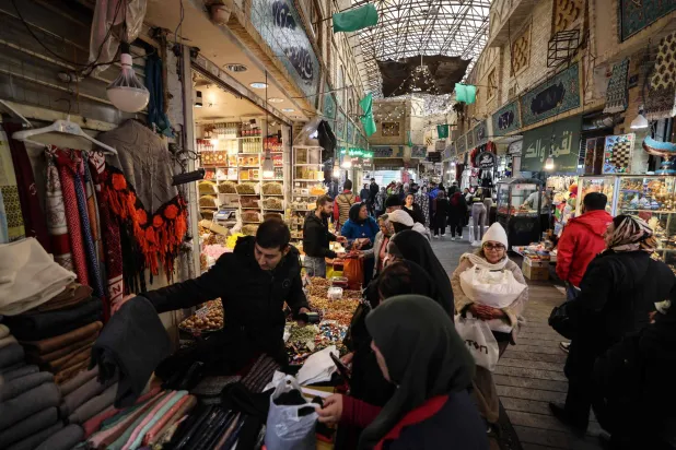  People shop at Tajrish Bazaar in the Iranian capital Tehran on December 29, 2025. (AFP)