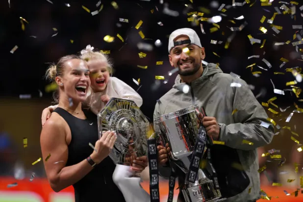  Tennis - 'Battle of the Sexes' - Nick Kyrgios v Aryna Sabalenka - Coca-Cola Arena, Dubai, United Arab Emirates - December 28, 2025 Belarus' Aryna Sabalenka, her goddaughter Nicole, and Australia's Nick Kyrgios celebrate with trophies after the match REUTERS/Amr Alfiky/Pool 