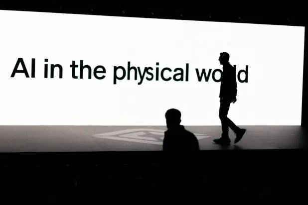 “Artificial intelligence in the physical world” is displayed on a screen during a conference showcasing advances in autonomous driving technology in California on Dec. 11, 2025. (Reuters) 