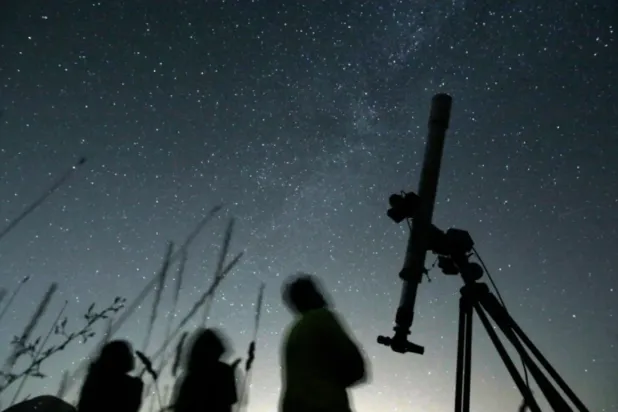 People look up to the sky from an observatory near the village of Avren, Bulgaria, Aug. 12, 2009. (AP Photo/Petar Petrov, File)
