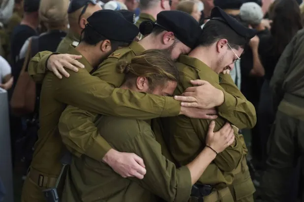 Israeli soldiers mourn reservist Master sergeant Asaf Cafri, 26, who was killed in Israel's ground operation in the Gaza Strip, during his funeral. (AP)