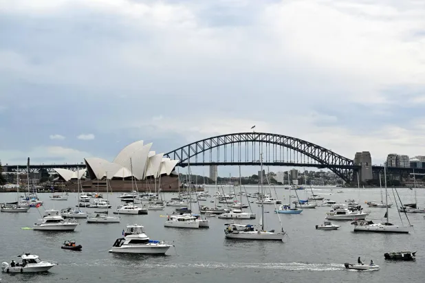 Residents secure spots for their boats near the Sydney Opera House ahead of the New Year's Eve fireworks display in Sydney on December 31, 2025. (AFP)