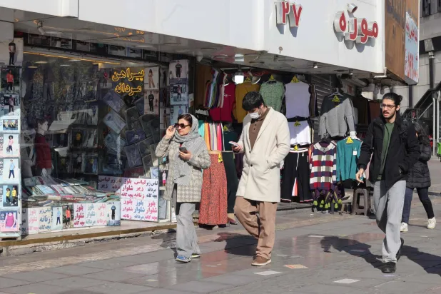 Iranians walks past shops in Vali-Asr Square in the Iranian capital Tehran, on the last day of the year on December 31, 2025. (AFP)