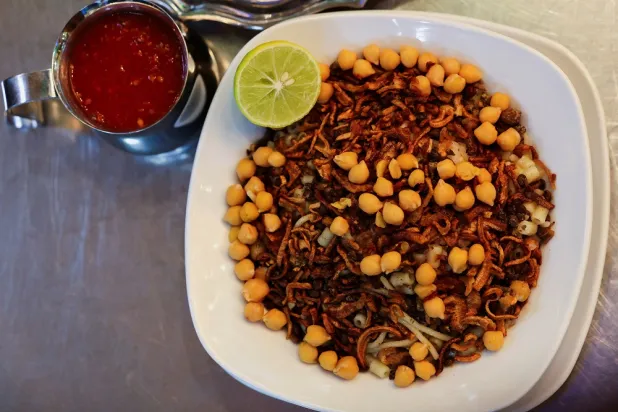 Koshary, an Egyptian vegan dish recognized by UNESCO as part of its Intangible Cultural Heritage, is plated in Cairo, Egypt, on December 9, 2025. (Reuters)