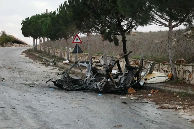A photograph shows the wreckage of a vehicle targeted by an Israeli airstrike on the road linking the southern Lebanese border village of Odeisseh to Markaba, on December 16, 2025. (AFP)