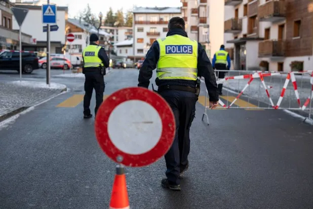  Police officers inspect the area where a fire broke out at the Le Constellation bar and lounge leaving people dead and injured, during New Year’s celebration, in Crans-Montana, Swiss Alps, Switzerland, Thursday, Jan. 1, 2026. (Alessandro della Valle/Keystone via AP) 