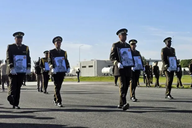 Military personnel carry portraits of the Libyan chief of staff, General Mohamed al-Haddad (2-R), and his four advisers, who were killed in a plane crash in Türkiye, during an official repatriation ceremony at the Ministry of Defense headquarters in Tripoli, Libya, 27 December 2025. (EPA) 