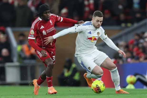 مدافع ليدز يونايتد غابرييل غودمونسون يحاول إيقاف مدافع ليفربول جيريمي فريمبونغ (أ.ف.ب)