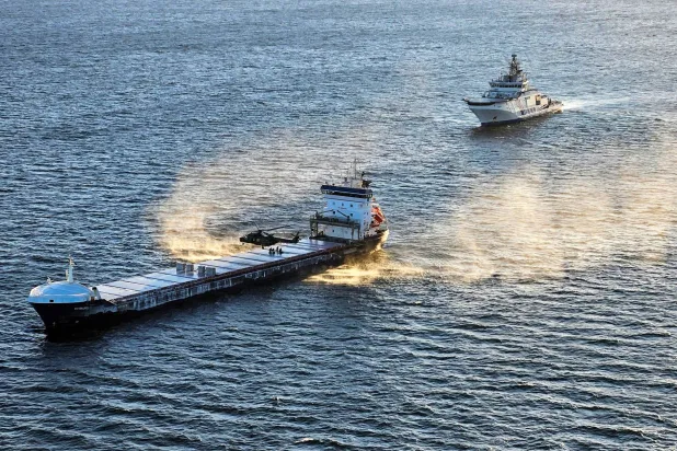 A Border Guard helicopter and a Coast Guard patrol ship Turva seize the Fitburg vessel suspected of a subsea cable breach in the Gulf of Finland on 31 December 2025, in this handout picture obtained on January 1, 2026. Finnish Police/Handout via REUTERS  