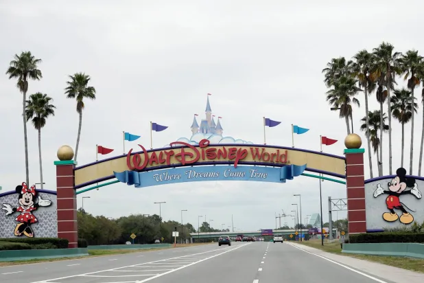 FILE - The road to the entrance of Walt Disney World, Monday, March 16, 2020, in Lake Buena Vista, Fla.  (AP Photo/John Raoux, File)