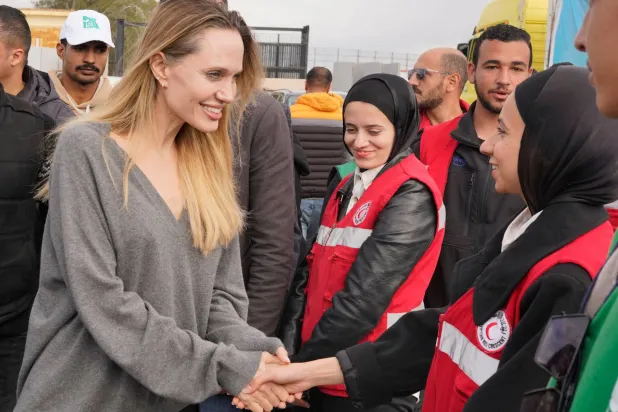 أنجلينا جولي مع كوادر «الصليب الأحمر» في معبر رفح جنوب قطاع غزة أمس (أ.ب)