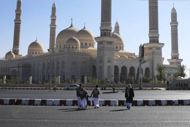 People walk past the Al-Shaab Mosque in Sana'a, Yemen, 01 January 2026. EPA/YAHYA ARHAB
