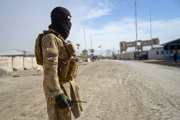 This photograph taken on December 29, 2025 shows a Taliban security personnel standing guard near the zero-point border crossing between Afghanistan and Pakistan at the Spin Boldak district of Kandahar province. (Photo by Sanaullah SEIAM / AFP) 
