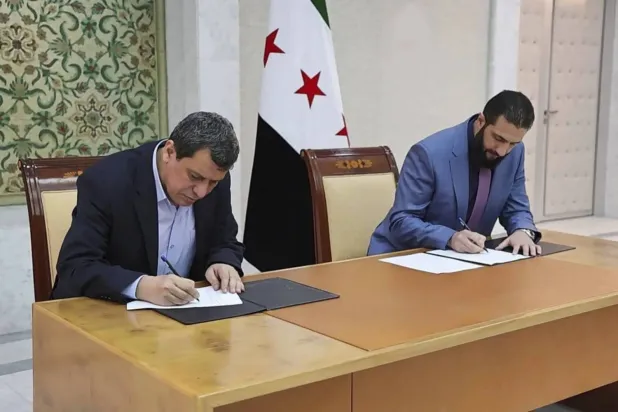 Syrian President Ahmed al-Sharaa signed a deal in Damascus last March with SDF commander Mazloum Abdi on integrating the force into state institutions (AP)