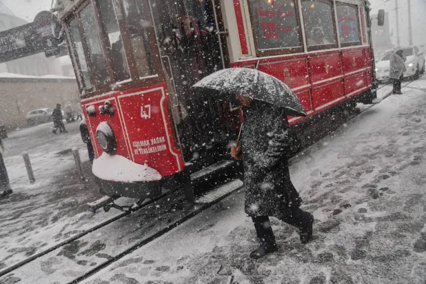 People walk along Taksim square during the first snowfall of the year, in Istanbul, Türkiye, Thursday, Jan. 1, 2026. (AP)