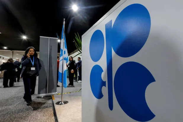 FILE PHOTO: A woman passes by a logo of Organization of the Petroleum Exporting Countries (OPEC) during the United Nations climate change conference COP29, in Baku, Azerbaijan November 13, 2024. REUTERS/Maxim Shemetov/File Photo