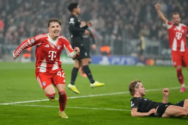 Bayern's Lennart Karl, left, celebrates after scoring his side's second goal during the Champions League opening phase soccer match between FC Bayern Munich and Sporting CP in Munich, Germany, Tuesday, Dec. 9, 2025. (AP Photo/Matthias Schrader)