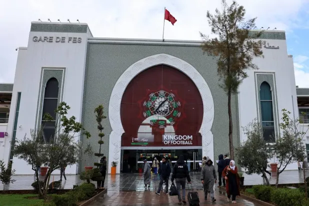 Employees and passengers walk in front of Fes Railway Station, which is decorated with Africa Cup of Nations (AFCON) theme colors, in the Moroccan city of Fes, January 5, 2026. (Reuters) 