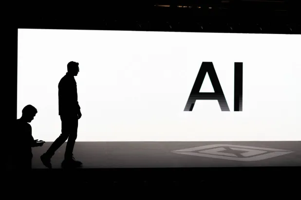 شاشة تعرض حرفي «إيه آي» خلال «يوم القيادة الذاتية والذكاء الاصطناعي» لشركة «ريفان» في بالو ألتو خلال ديسمبر 2025 (رويترز)